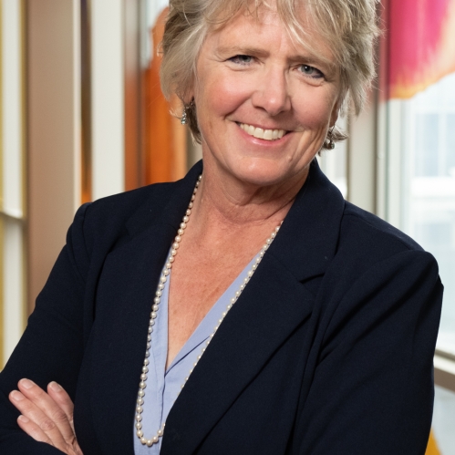 woman with folded arms smiling
