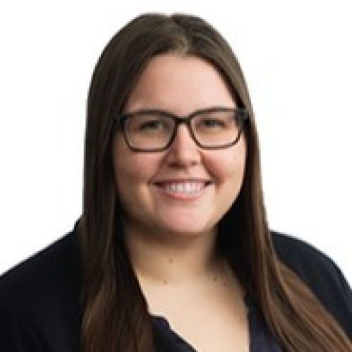 a woman with glasses smiling
