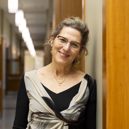 a woman with glasses smiling