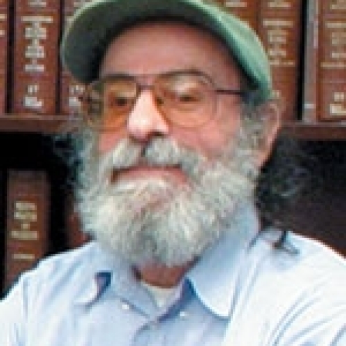 a man with a beard and glasses smiling