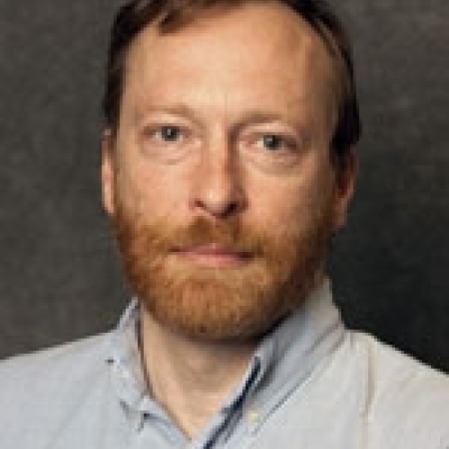 a man with a beard smiling