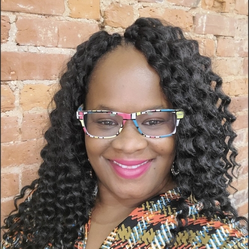 a woman with glasses smiling