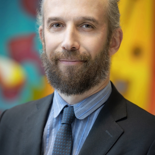 a man with a beard smiling