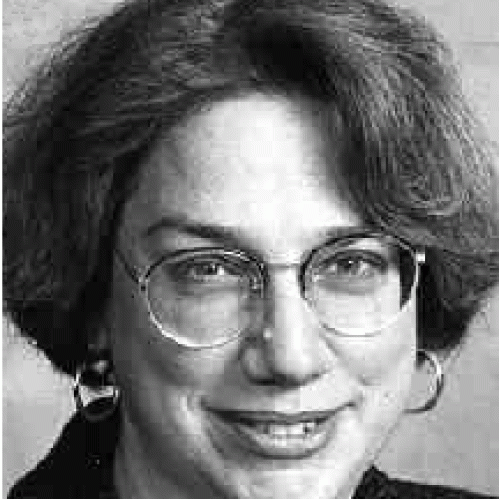 a woman with glasses smiling