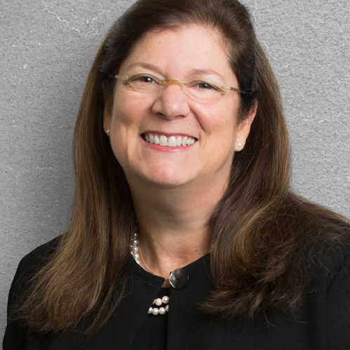 a woman with glasses smiling