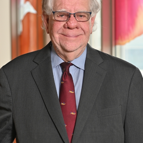 a man with glasses smiling