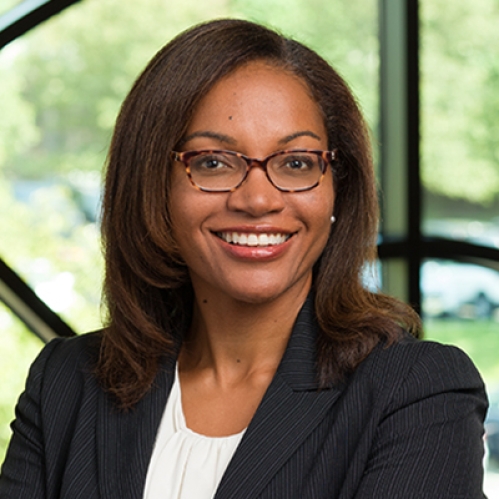 a woman with glasses smiling