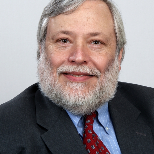 a man with a beard smiling