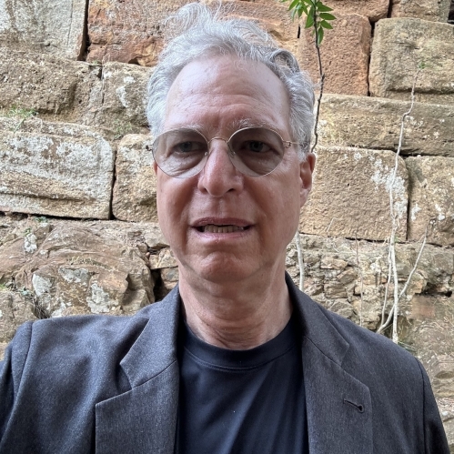 man in shades in front of ancient stones of a Roman aqueduct in Algeria