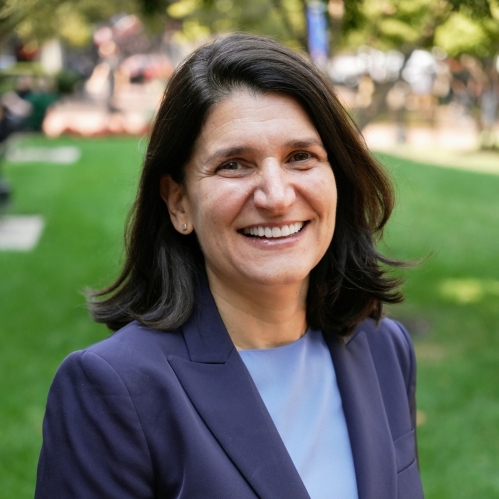 woman in dark blue blazer smiling