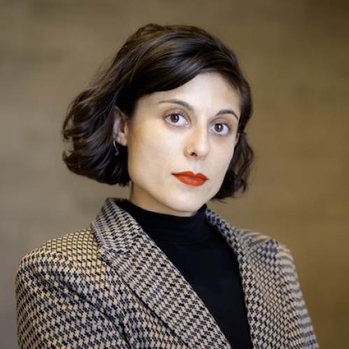 woman in blazer looking ahead