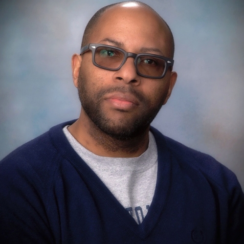 Man with glasses wearing sweater turtleneck