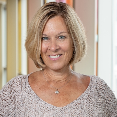 Woman grinning wearing knit top