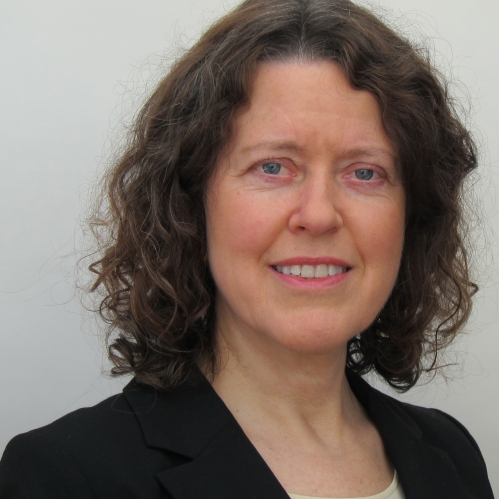 Woman grinning wearing black suit jacket
