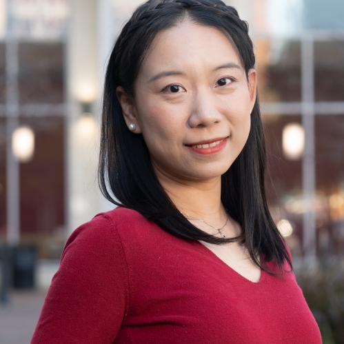Woman smiling wearing a red shirt.
