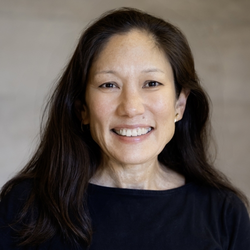 woman in black shirt smiling