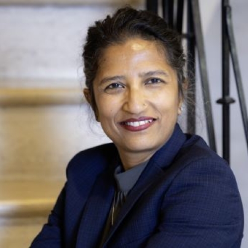 woman smiling and sitting on stairs