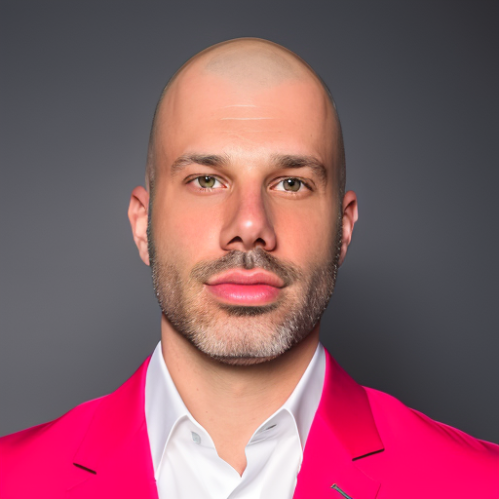 headshot of man wearing white shirt and hot pink blazer