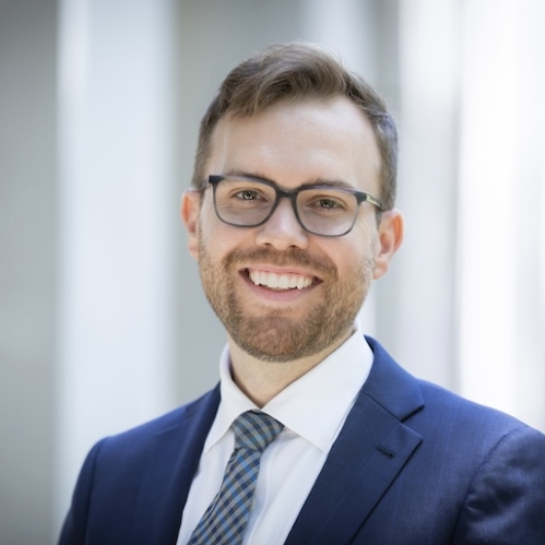 man in blue suit smiling