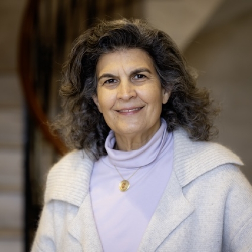 woman in front of staircase wearing white jacket
