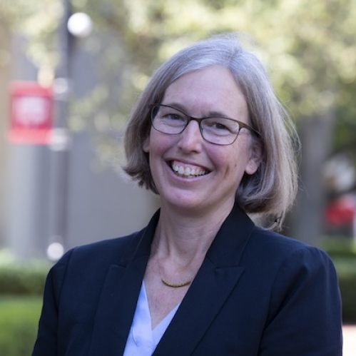 woman outside wearing glasses and smiling