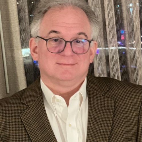 Man wearing glasses in front of window