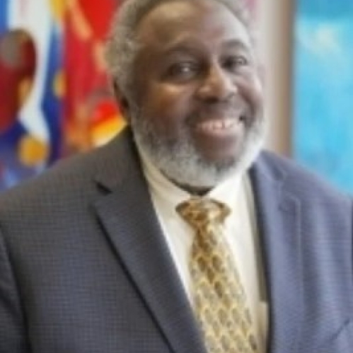Man smiling wearing yellow patterned tie