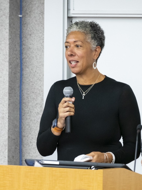 Woman speaking on mic at podium