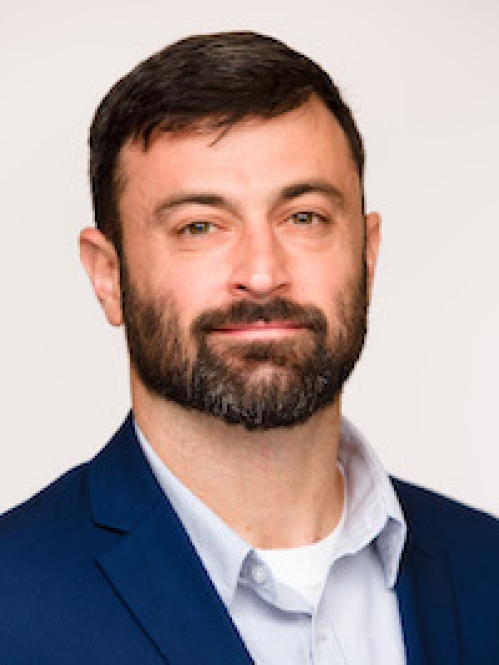 a man with a beard smiling