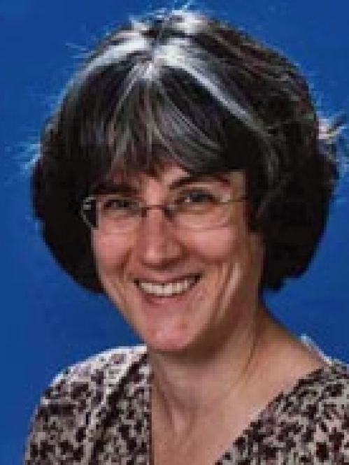 a woman with glasses smiling