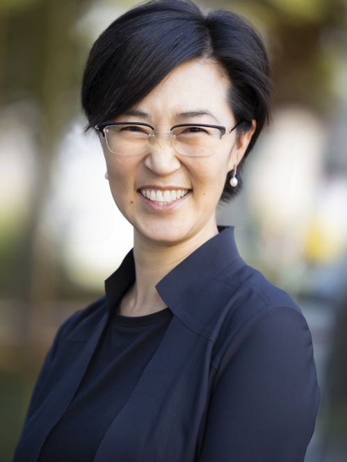 a woman with glasses smiling