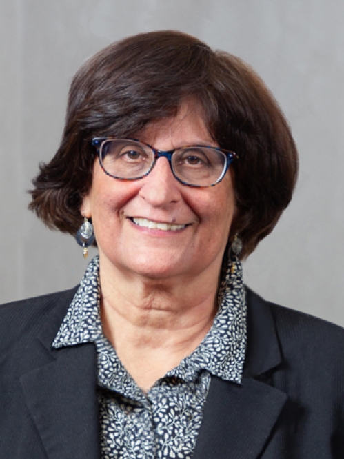 a woman with glasses smiling