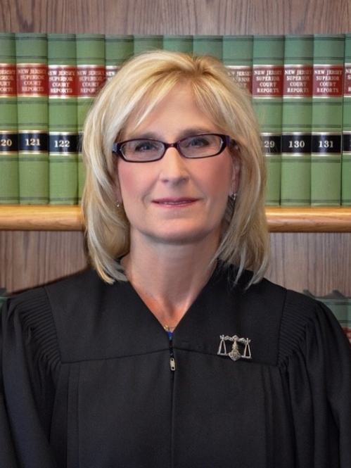 a blonde woman with glasses smiling