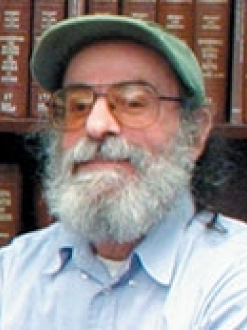 a man with a beard and glasses smiling