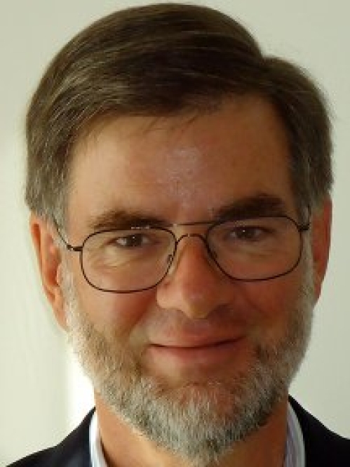 a man with a beard and glasses smiling
