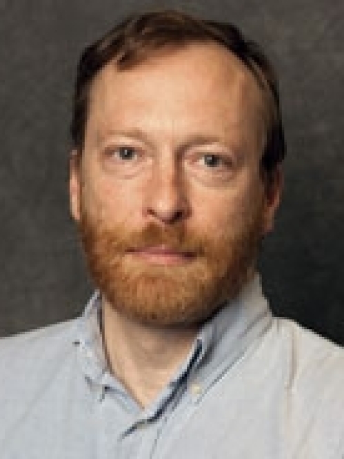 a man with a beard smiling