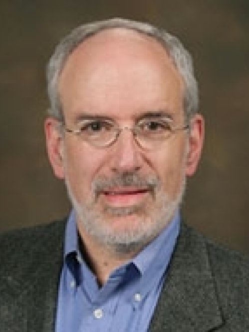 a man with a beard and glasses smiling