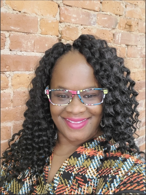 a woman with glasses smiling