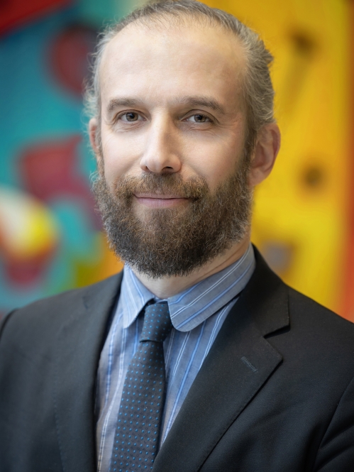 a man with a beard smiling