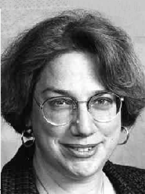 a woman with glasses smiling