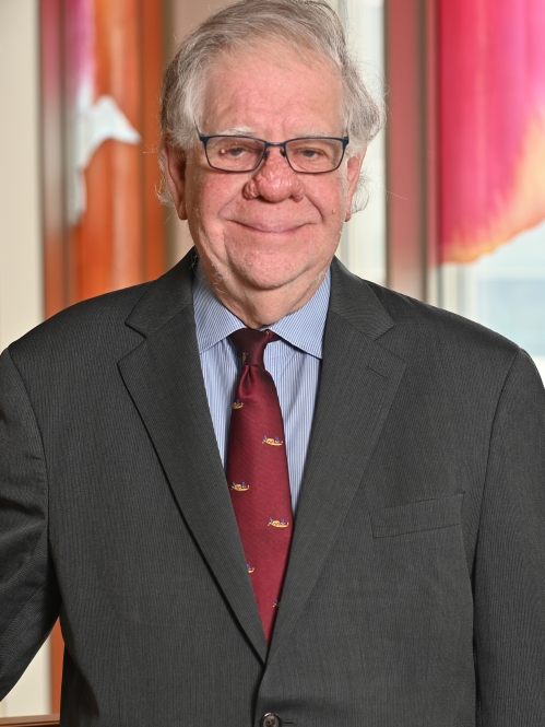 a man with glasses smiling
