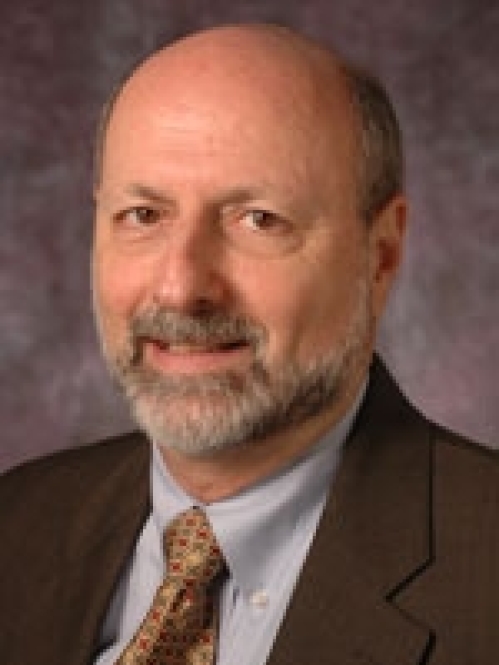 a man with a beard smiling