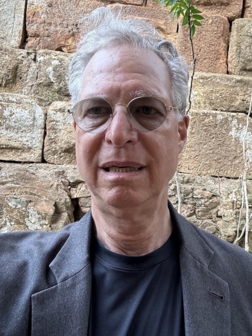 man in shades in front of ancient stones of a Roman aqueduct in Algeria