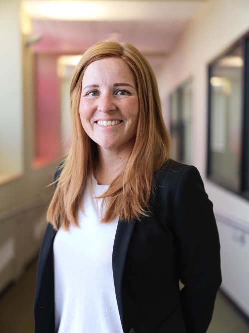 women in black blazer smiling