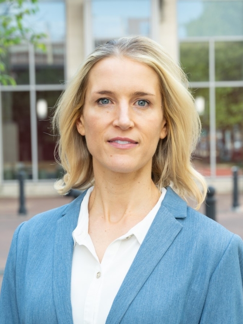 woman in blue blazer standing outside