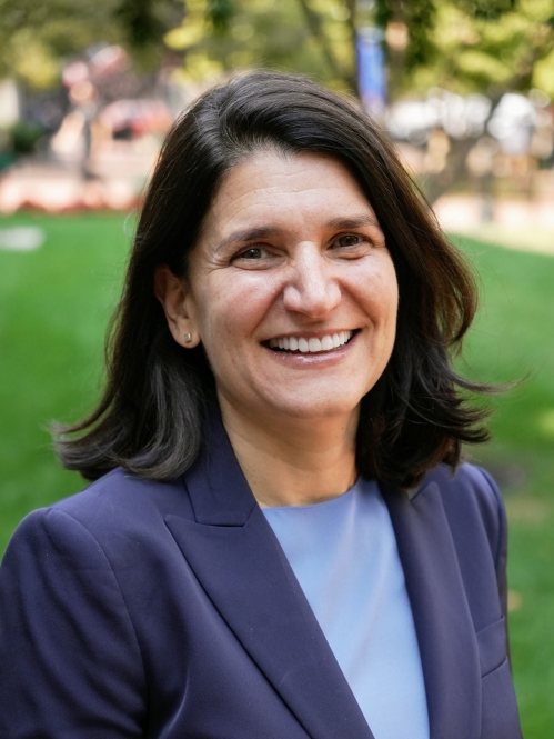 woman in dark blue blazer smiling