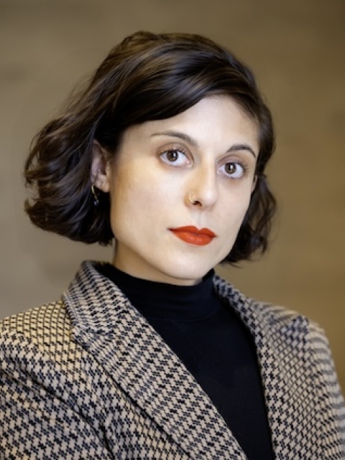 woman in blazer looking ahead