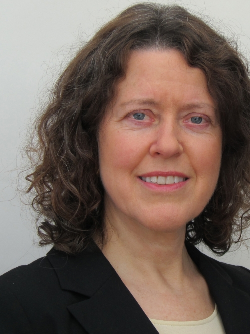 Woman grinning wearing black suit jacket