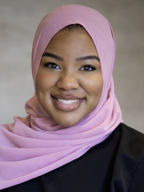 woman in pink head covering smiling