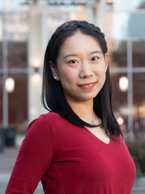 Woman smiling wearing a red shirt.